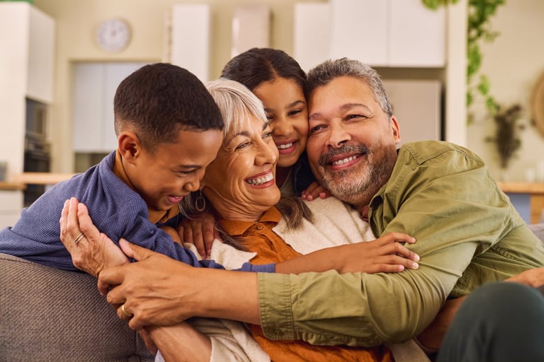 Lovely and happy multiethnic grandparents with grandchildren sitting on sofa together having fun